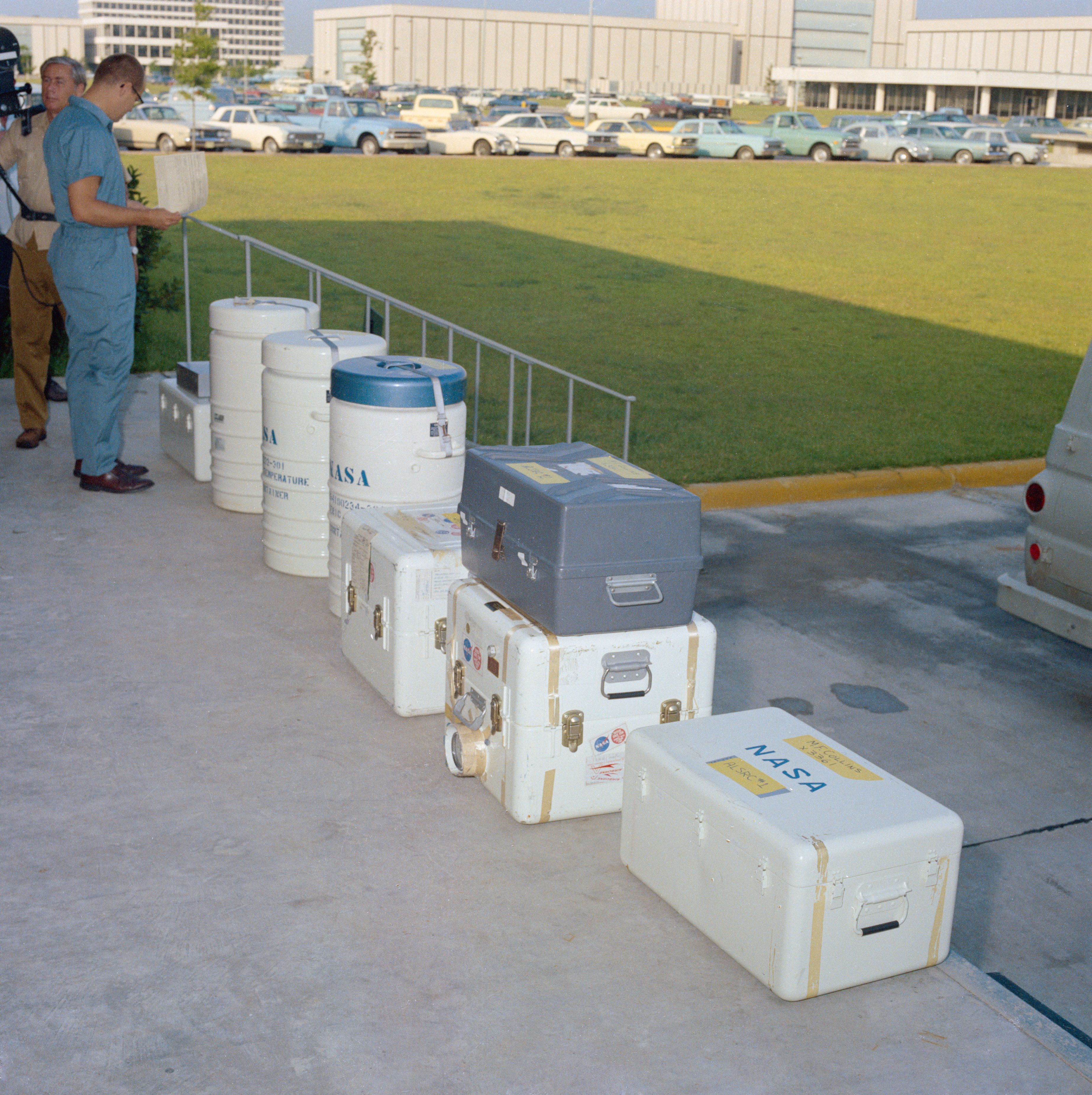 On the loading dock of the Lunar Receiving Laboratory (LRL) at the Manned Spacecraft Center, now NASA’s Johnson Space Center in Houston, workers simulate the arrival of the first Moon rocks and other items returned from Apollo 11