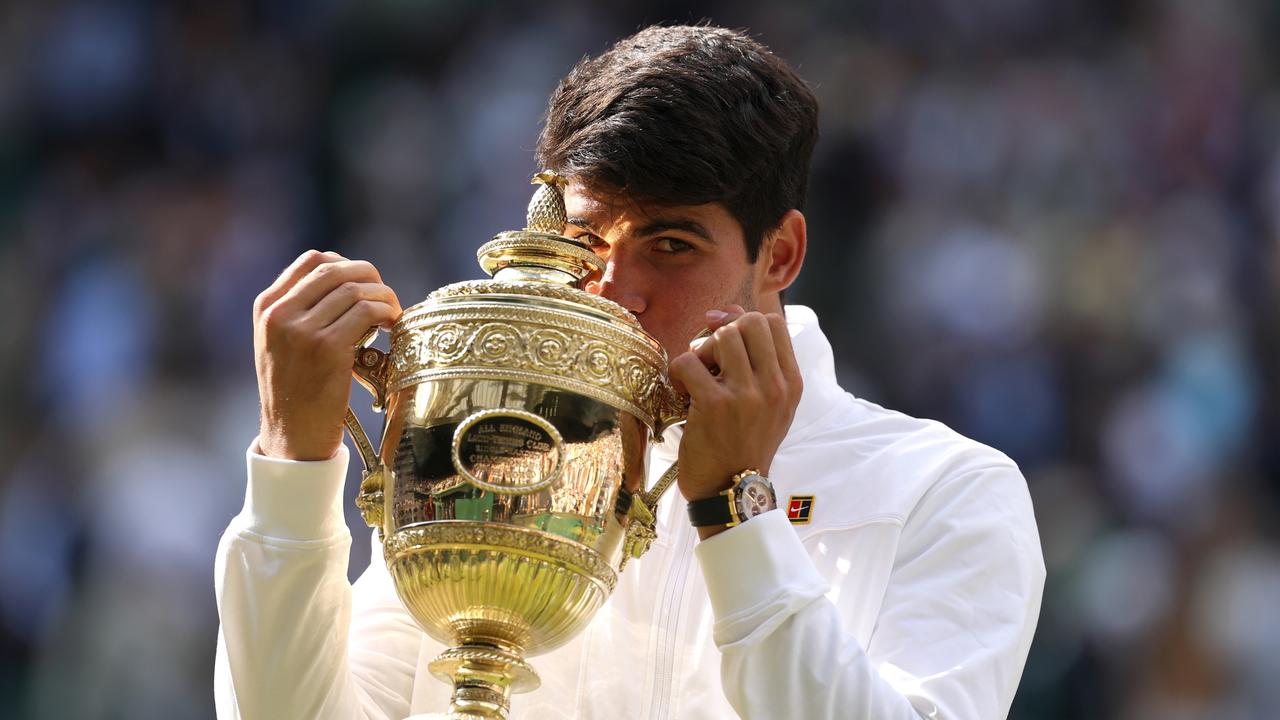 LONDON, ENGLAND - JULY 14: Carlos Alcaraz of Spain kisses the Gentlemen's Singles Trophy following victory against Novak Djokovic. (Photo by Julian Finney/Getty Images)