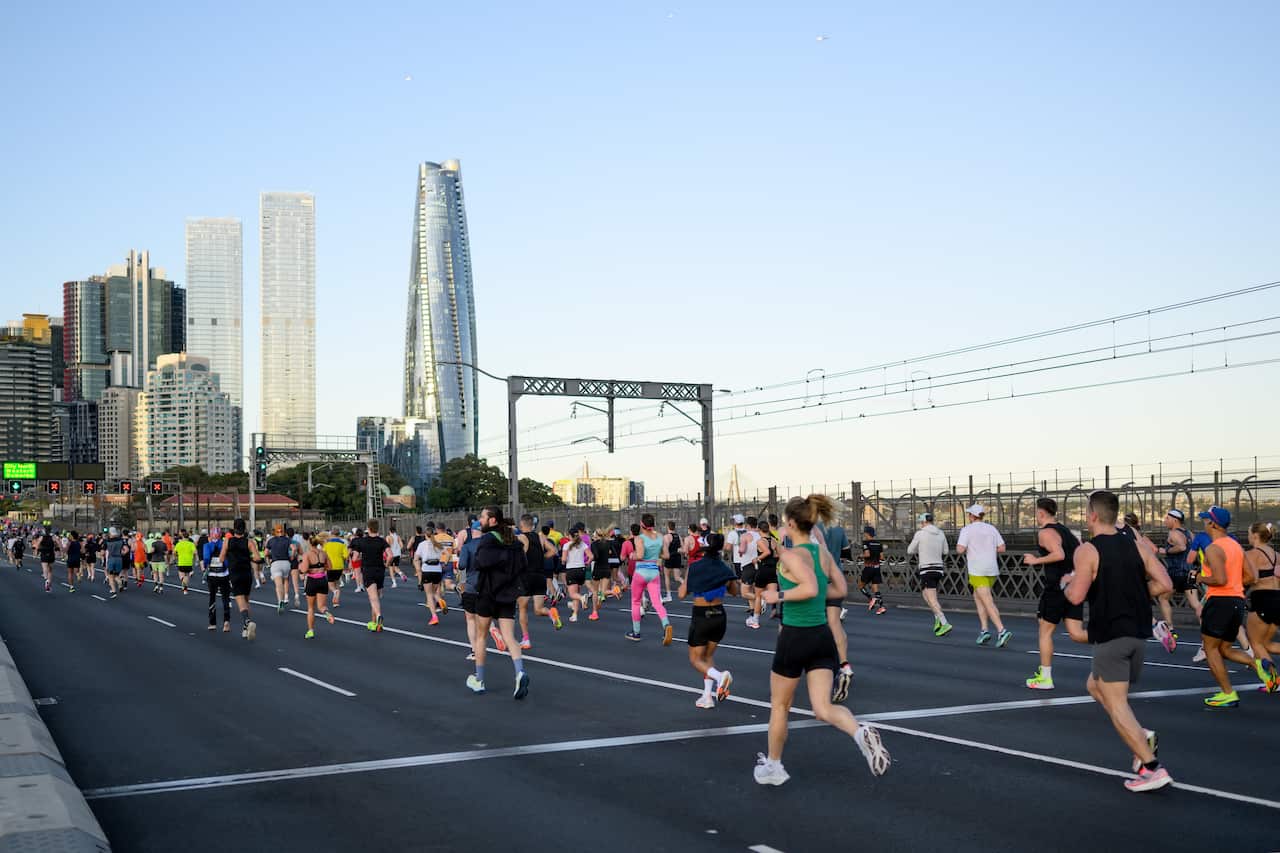 People run on a bridge as they take part in a marathon.