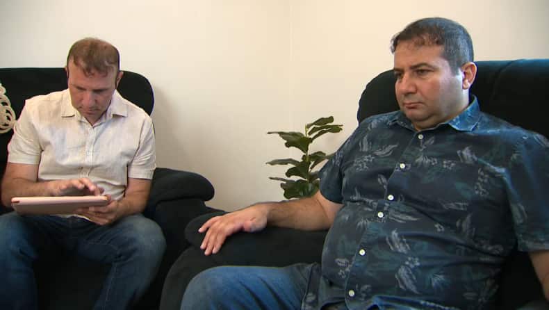 Two men sitting on couches.