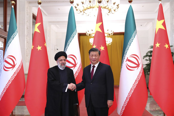 Now-dead Iranian president Ebrahim Raisi, left, shakes hands with his Chinese counterpart Xi Jinping in Beijing in 2023.