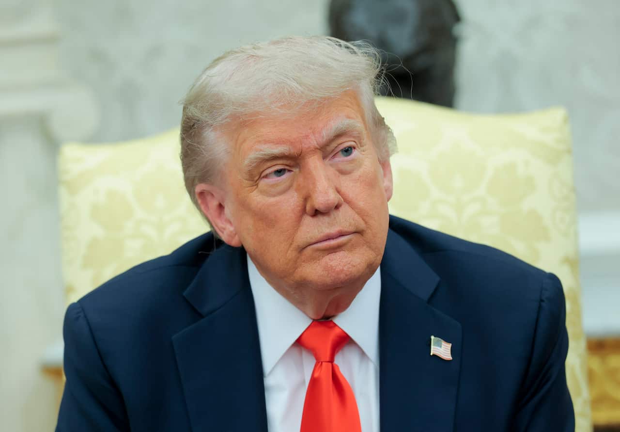 Donald Trump sitting in a yellow chair.