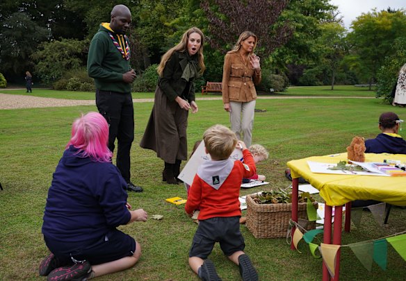 Chief Scout Dwayne Fields (left) introduces the princess of Wales and first lady Melania Trump to some young scouts in Frogmore Gardens.