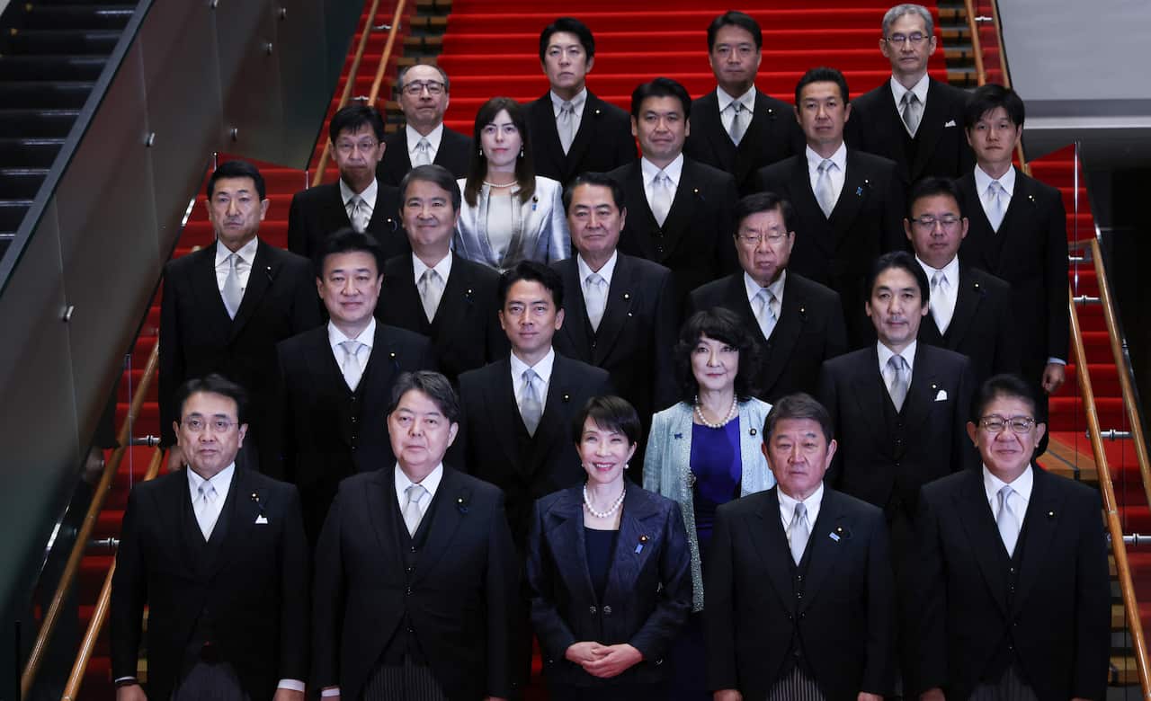 A group of people pose for a photo on a staircase