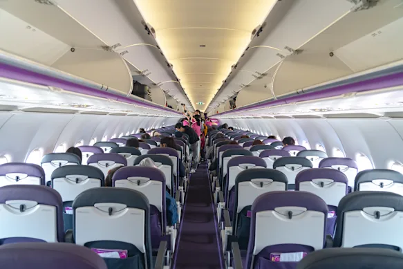 Inside an Airbus A320-200 aircraft cabin.