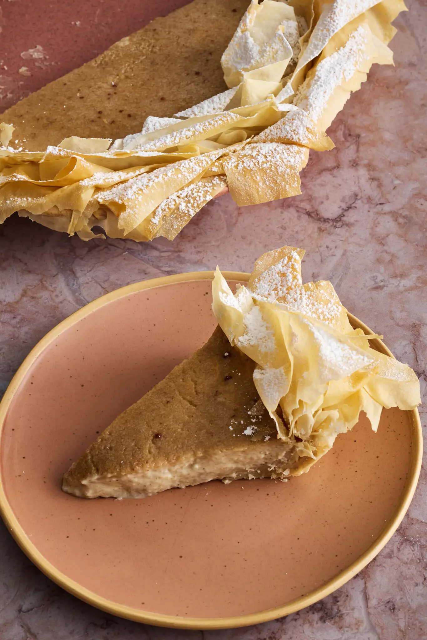 A three-quarter image of a banana pie with a phyllo crust.