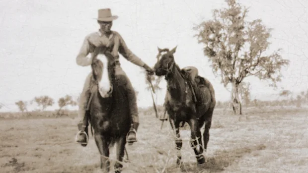 Lovell leading a horse.