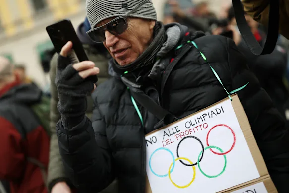 A protester objects to the costs of staging the Winter Olympics in Milan.