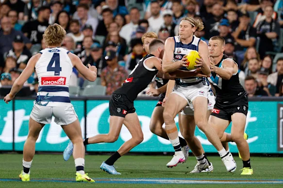 Mark Blicavs is tackled by Ollie Wines.