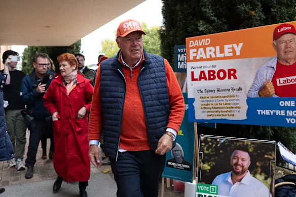 One Nation candidate David Farley and party leader Pauline Hanson arrive at an Albury polling booth on Friday. 