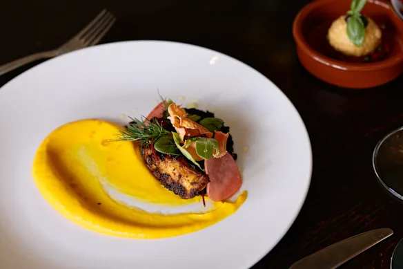 Western Australia octopus tentacle with smoked carrot puree and pickled radish.