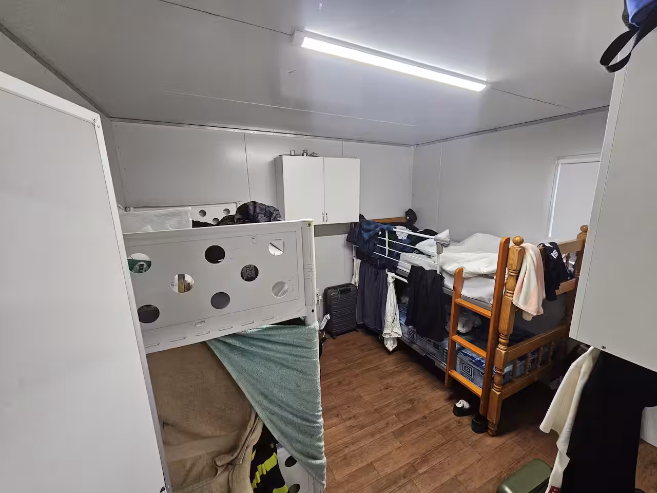 A photo of the inside of a small caravan, fitted with two bunk beds.