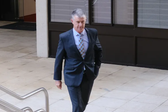 Tim Mander arrives for his press conference at parliament late on Wednesday – his first in Brisbane since scrutiny of his personal life and public role began last month.