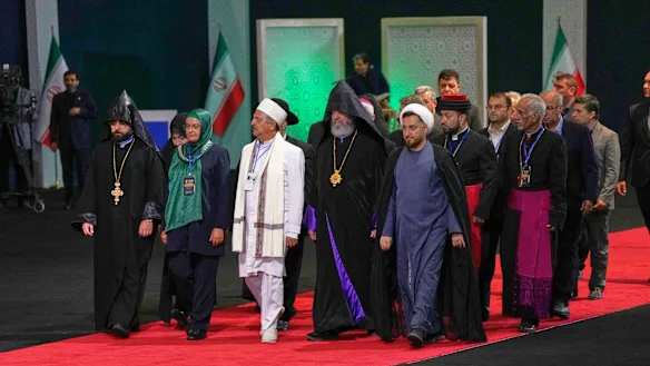 Religious leaders and other dignitaries walk past the coffin of Supreme Leader Ayatollah Ali Khamenei in Tehran.
