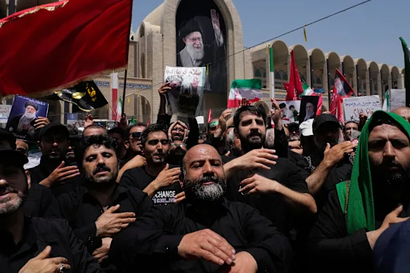 Mourners beat their chests as they attend the dayslong funeral ceremonies for the late Iranian Supreme Leader Ayatollah Ali Khamenei.