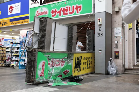 A store sign of a restaurant is seen fallen on the ground after an earthquake in Kumamoto in the Kyushu island, southern Japan,