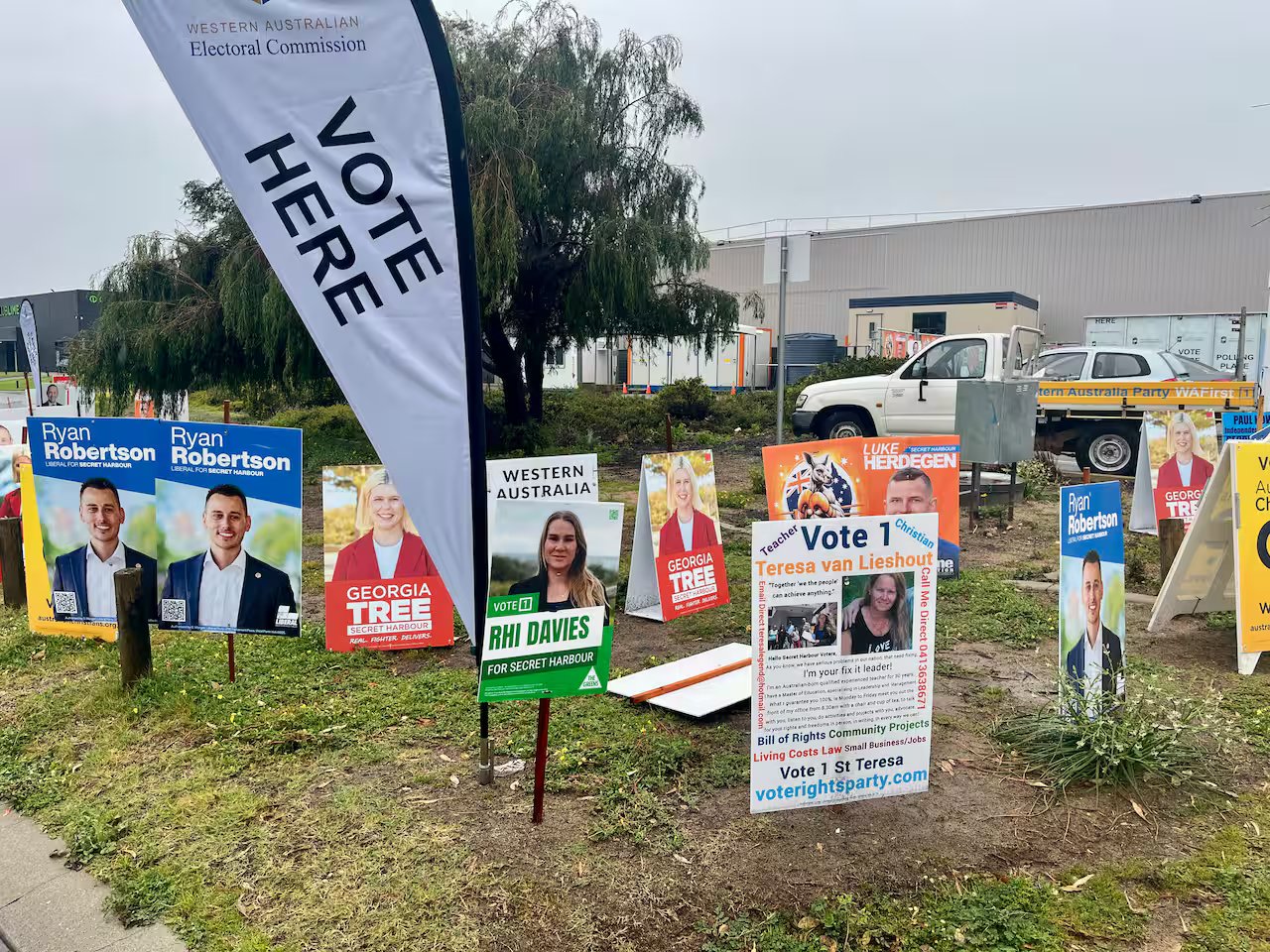 Corflutes signs showing different political candidates at a Western Australian by-election polling station.