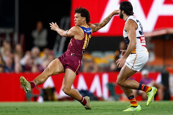 Cam Rayner of the Lions kicks a goal.