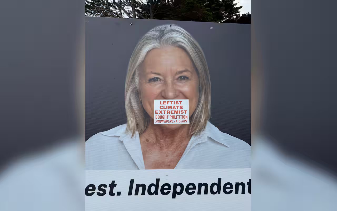 A poster of Tracee Hutchison with a sticker over her mouth