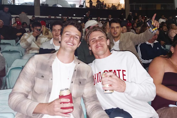 Tommy Cahill (left) and Charlie Farr-Jones in the stands on the final night of greyhound racing at Sydney’s Wentworth Park.