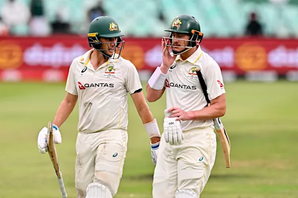Pat Cummins and Matt Renshaw leave the field due to bad light.