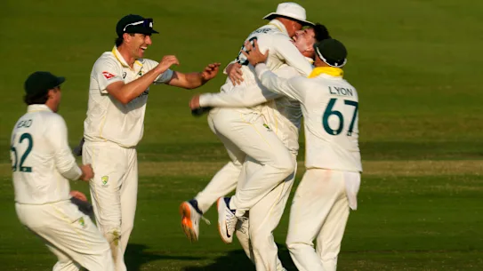 Matt Renshaw celebrates with teammates after taking a wicket on day four of the Test.