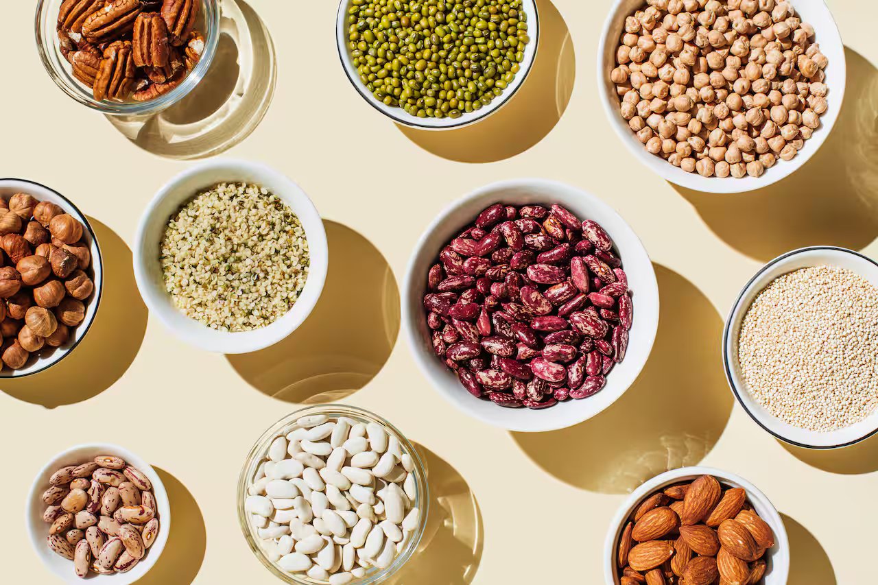 Various kinds of vegan protein sources on beige background.